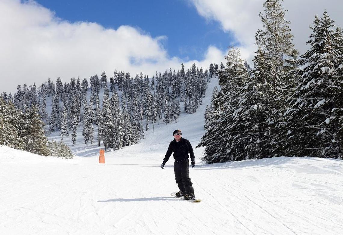 A snowboarder rides down a snowpacked slope on a powder-filled day in February 2017 at China Peak.