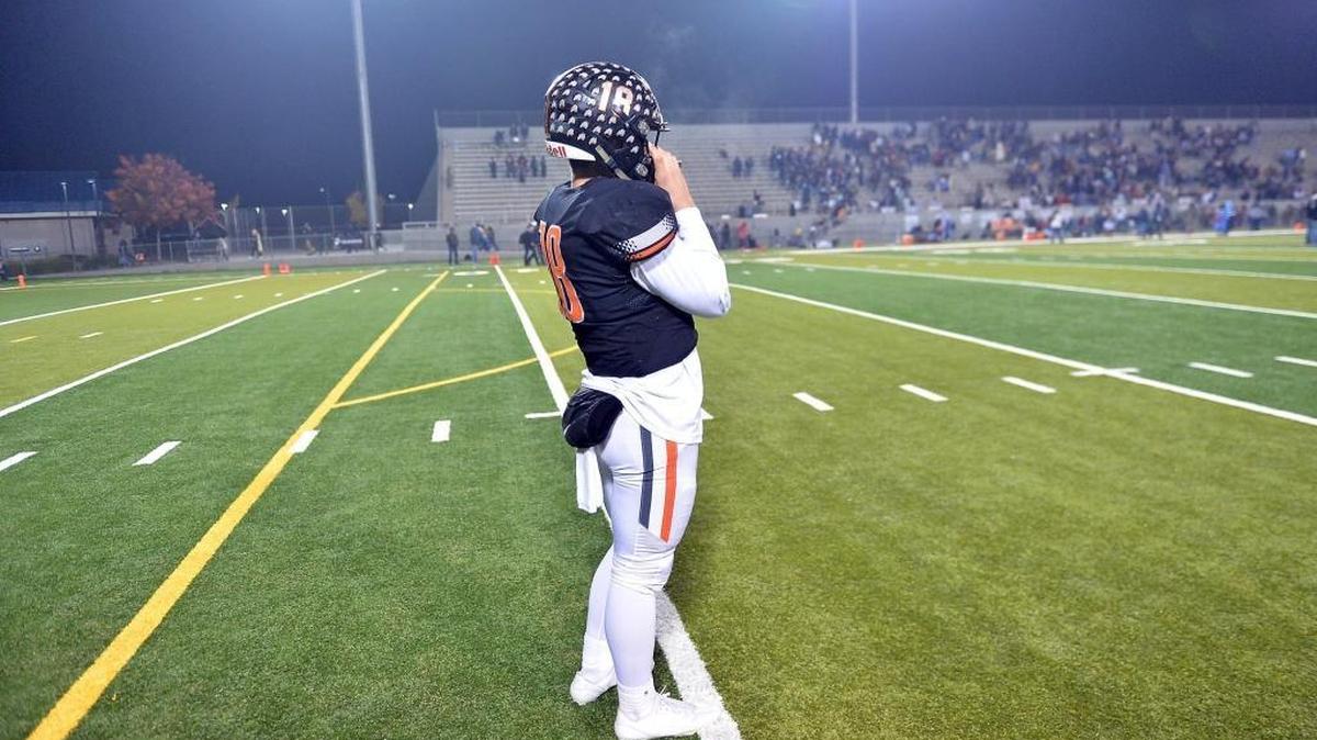 Central quarterback Trent Tompkins stands alone, stunned and grasping his facemask, following the Grizzlies’ 21-14 loss to Bakersfield in the Central Section Division I championship game Friday, Dec. 2, 2016 at Koligian Stadium. Tompkins shouldered the blame after throwing two costly interceptions.