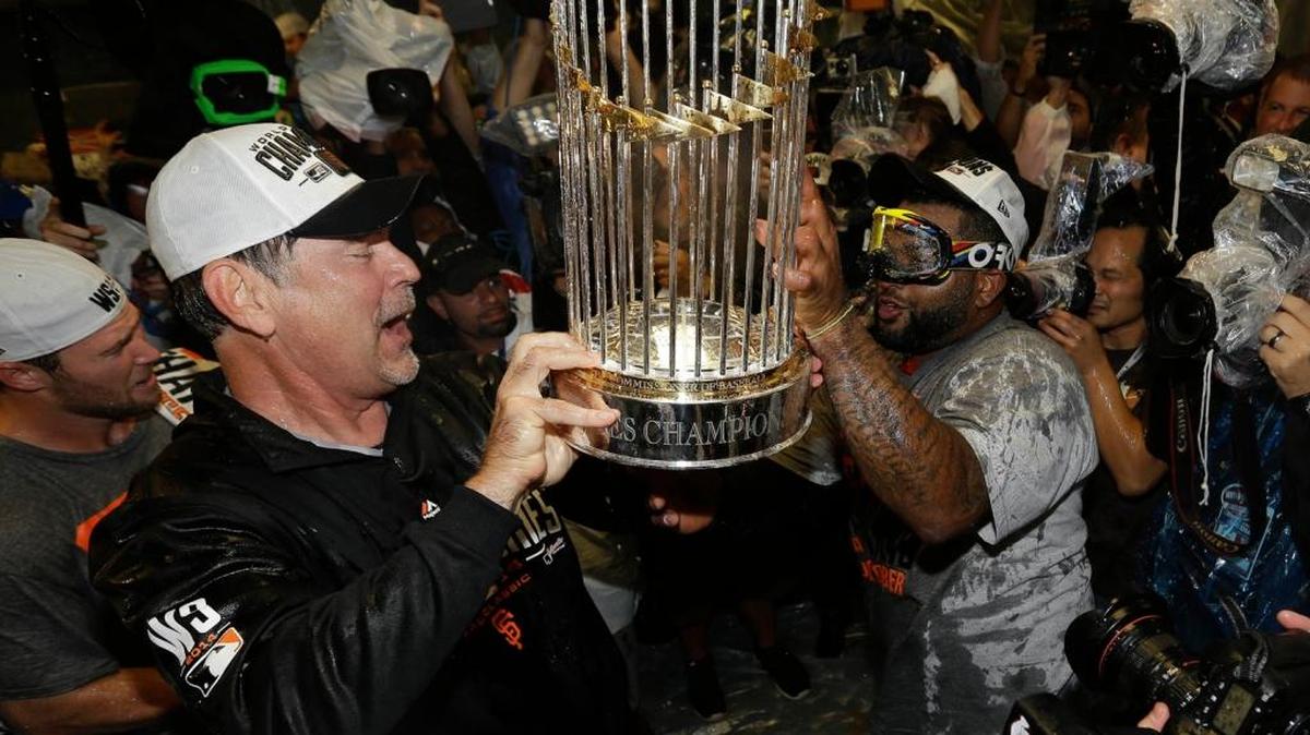 San Francisco Giants manager Bruce Bochy hands the championship trophy to Pablo Sandoval as they celebrate a World Series championship in 2014. It’s two years later. An even year. Does that mean ... ? Nope, says Marek Warszawski.
