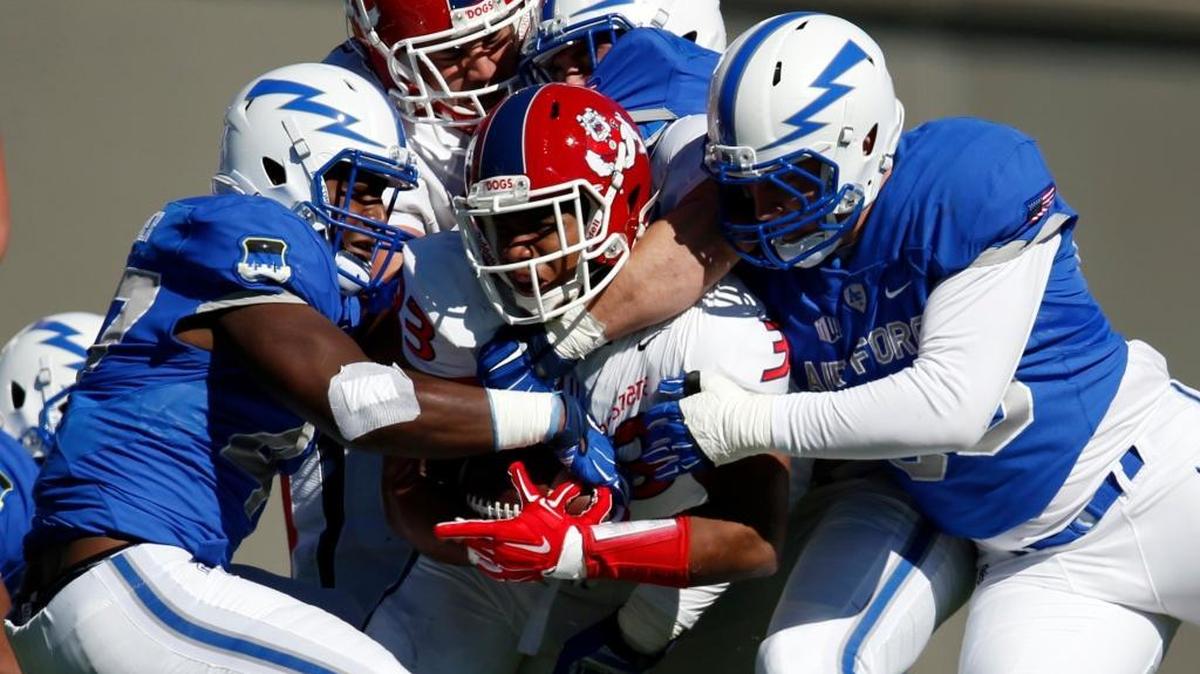 Fresno State running back Marteze Waller is stopped after a short gain by Air Force defensive back Tyler Weaver, left, and defensive lineman Samuel Byers in the first half Saturday. Waller had a 64-yard touchdown run early but was mostly bottled up after that as the Falcons beat the Bulldogs 42-14.