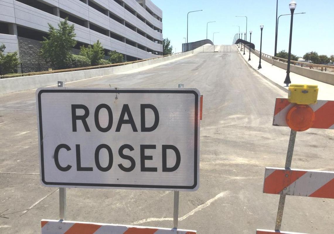 The eastern approach to the new Tuolumne Street bridge remains closed to traffic in downtown Fresno. Contractors are being required to make repairs to the concrete surface of the bridge deck to make it smooth enough for cars once the bridge opens.