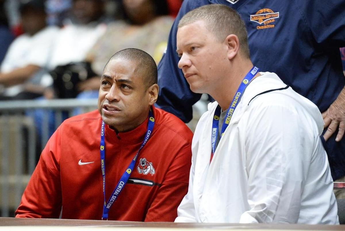 Fresno State men's basketball coach Rodney Terry, left, and Clovis East boys basketball coach Adrian Wiggins watch warm-ups before the start of a 2017 Central Section championship game at Selland Arena.