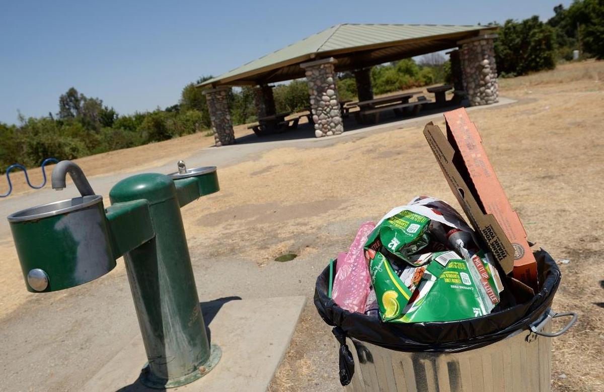 Trash piles up in a trash can in a picnic area in the Jensen River Ranch north of Woodward Park on July 7, 2017. City crews do not empty the trash or maintain the restroom, which has been closed since 2014.
