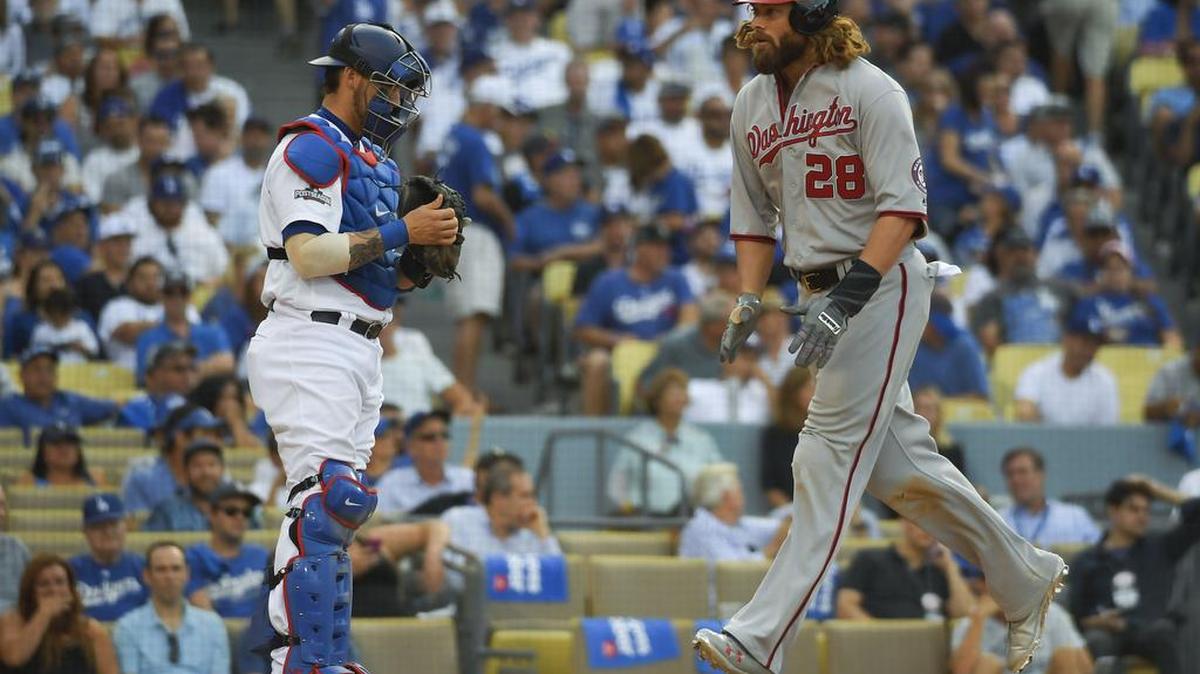 The Washington Nationals’ Jayson Werth, right, celebrates after his home run as Los Angeles Dodgers catcher Yasmani Grandal looks on during the ninth inning in Game 3 of baseball’s National League Division Series in Los Angeles, Monday, Oct. 10, 2016.