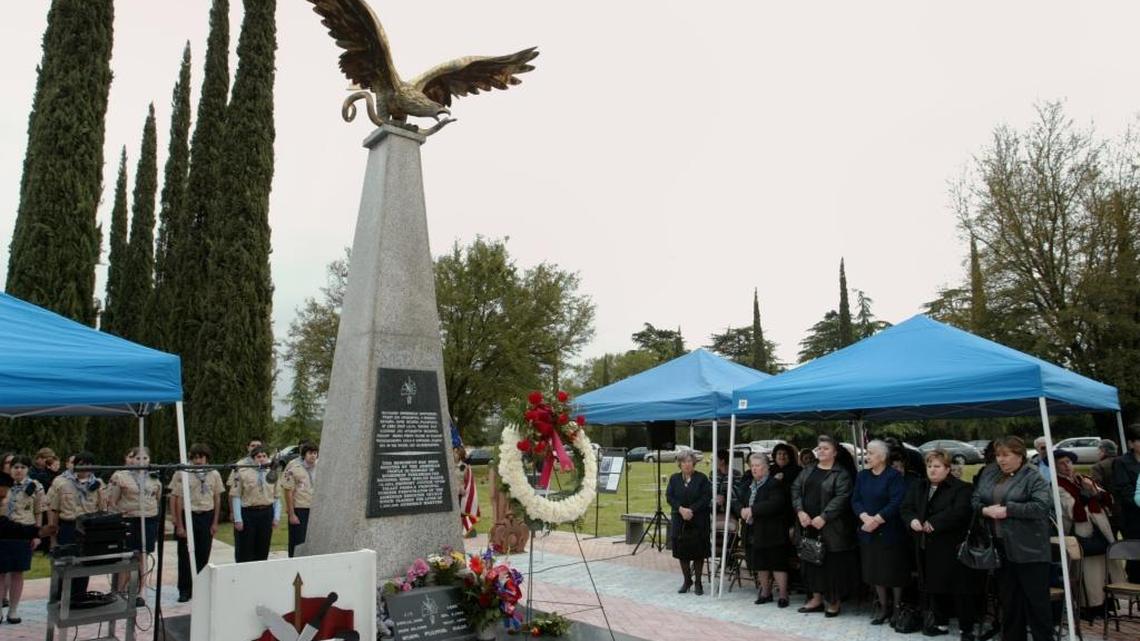People stand and sing during a memorial service for Soghomon Tehlirian at Masis Ararat Cemetery on April 23, 2006. The monument to the Armenian hero was created in 1969 and renovated in 1995.