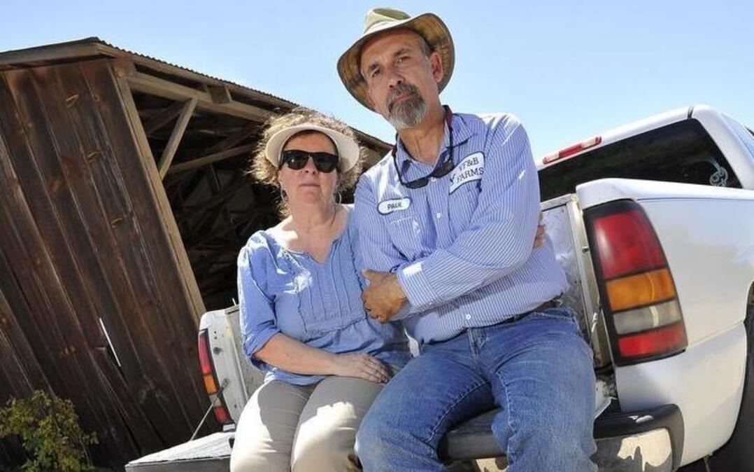 
Paul and Sheryl Betancourt at the barn on their Kerman farm built in the 1930s by her grandfather.
