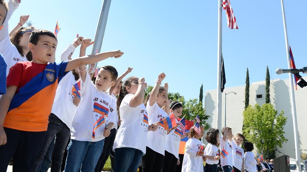 School kids from the St. Paul Saturday Armenian School of Fresno sing during the annual Armenian Flag raising ceremony to commemorate the victims and survivors of the Armenian Genocide, outside Fresno City Hall on Saturday, April 21, 2018.