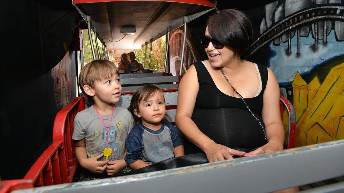 
Asher Cawdery, 3, of Sanger enjoys the train ride through the tunnel with brother Noah, 1, and mom Nadine Cawdery, at the Sept. 4 grand reopening of Storyland. 

