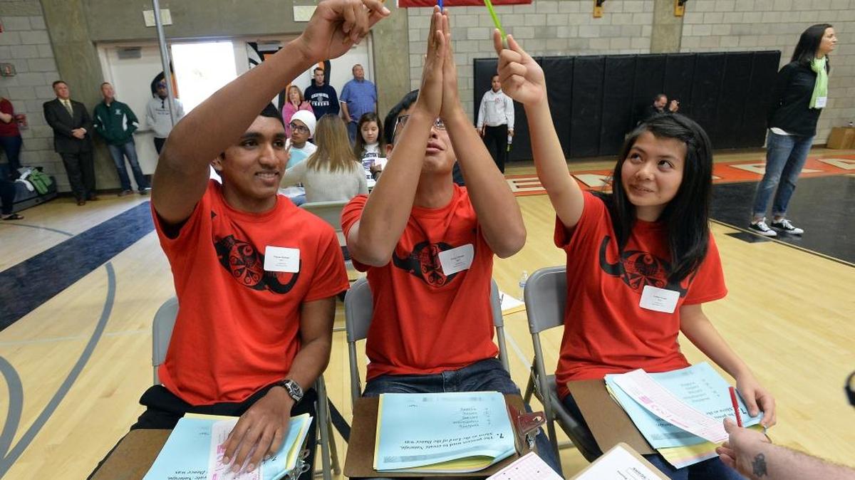 From left, University High School students Fayyaz Ahmed, Philip Canoza and Lillian Torres compete in the Super Quiz competition of the 34th Annual Fresno County Academic Decathlon on Saturday, Feb. 6, at Central East High School in Fresno.