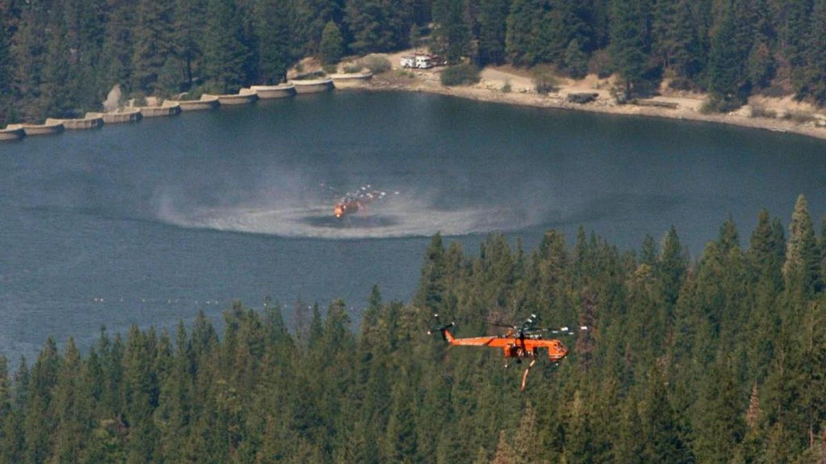 
Helicopters take water from Hume Lake to help contain the Rough fire on Aug. 24.
