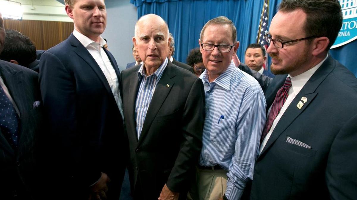 In this July 17, 2017, photo Gov. Jerry Brown, second from left, is flanked by three of the eight Republicans who voted with the Democratic majority to extend California’s cap-and-trade program despite opposition from much of the GOP base. They are Assembly Leader Chad Mayes, of Yucca Valley, left, Sen. Tom Berryhill, of Twain Harte, and Assemblyman Devon Mathis, of Visalia, right.
