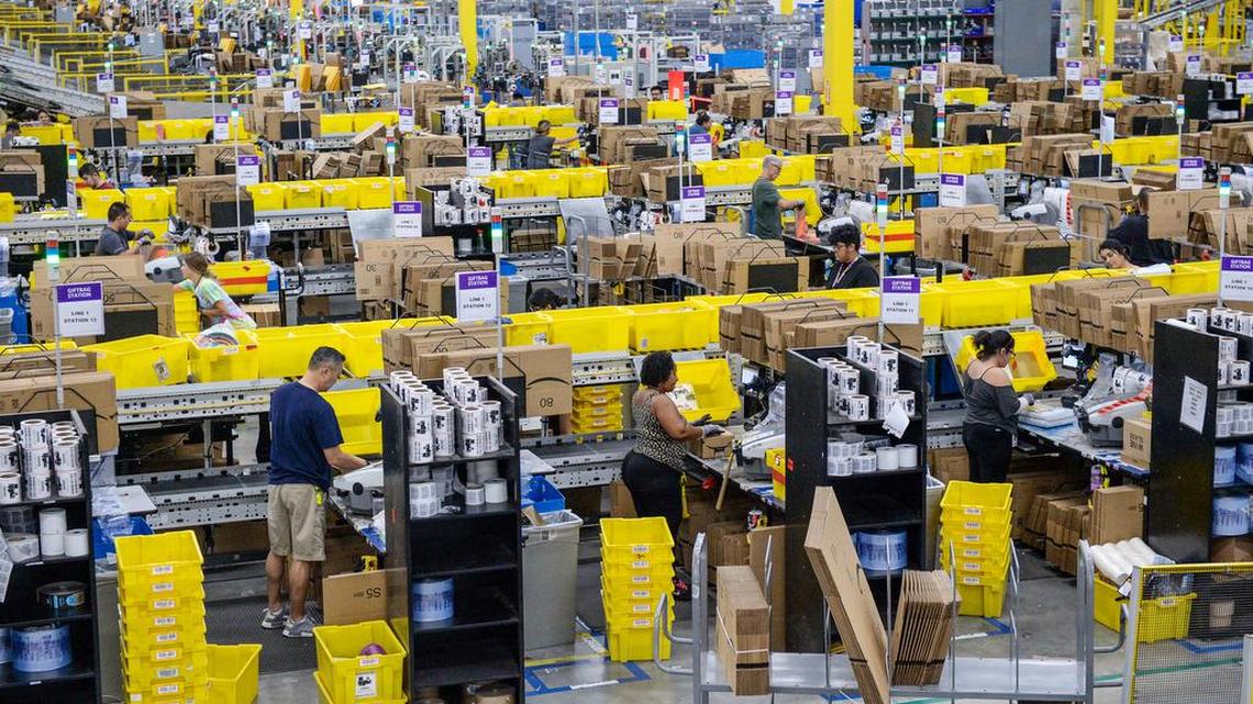 Workers package products for customers at the Amazon fulfillment center in south Fresno on Tuesday, July 24, 2019.