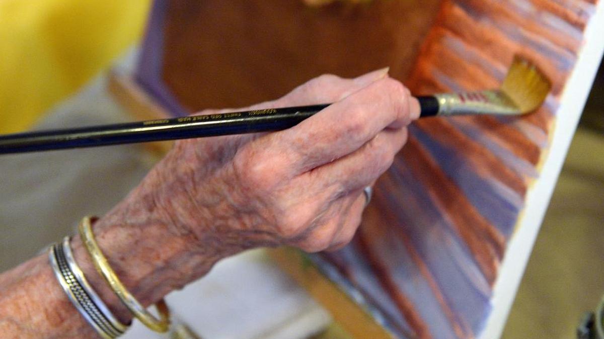 The hand of Dorris Woods of Fresno on a painting at Seago’s studio in Fresno on Monday, June 12, 2017. Retired educator Shirley Bruegman has realized she, too, can learn to paint.