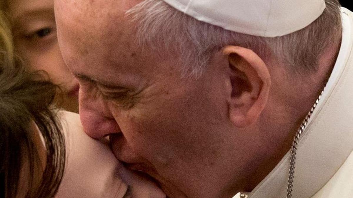 Pope Francis kisses a child at the end of his weekly general audience in the Paul VI Hall last week at the Vatican.