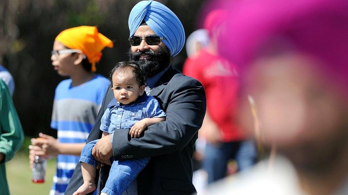 Simmer Singh carries his 1-year-old nephew Angad Singh during the 2016 Sikh Day Nagar Kirtan Parade for Vaisakhi celebrations in Selma.