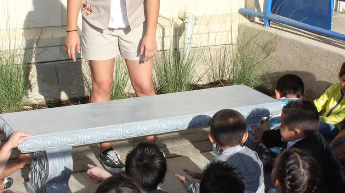 Girl Scout Kasey Justesen talks to local kindergarteners about the importance of knowing your surroundings and safety. Kasey recognized that this class had children waiting right near an open road where cars fly by. She worked to put a bench in front of the class to give the children a place to sit and wait.