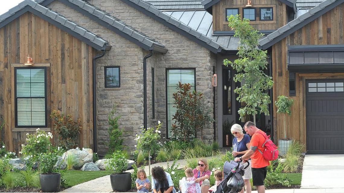 CalFire firefighter Nick Reeder, right, and family, gather at their new home, courtesy of Extreme Makeover: Home Edition and De Young Properties, before a press conference Monday, Aug. 5, 2019.