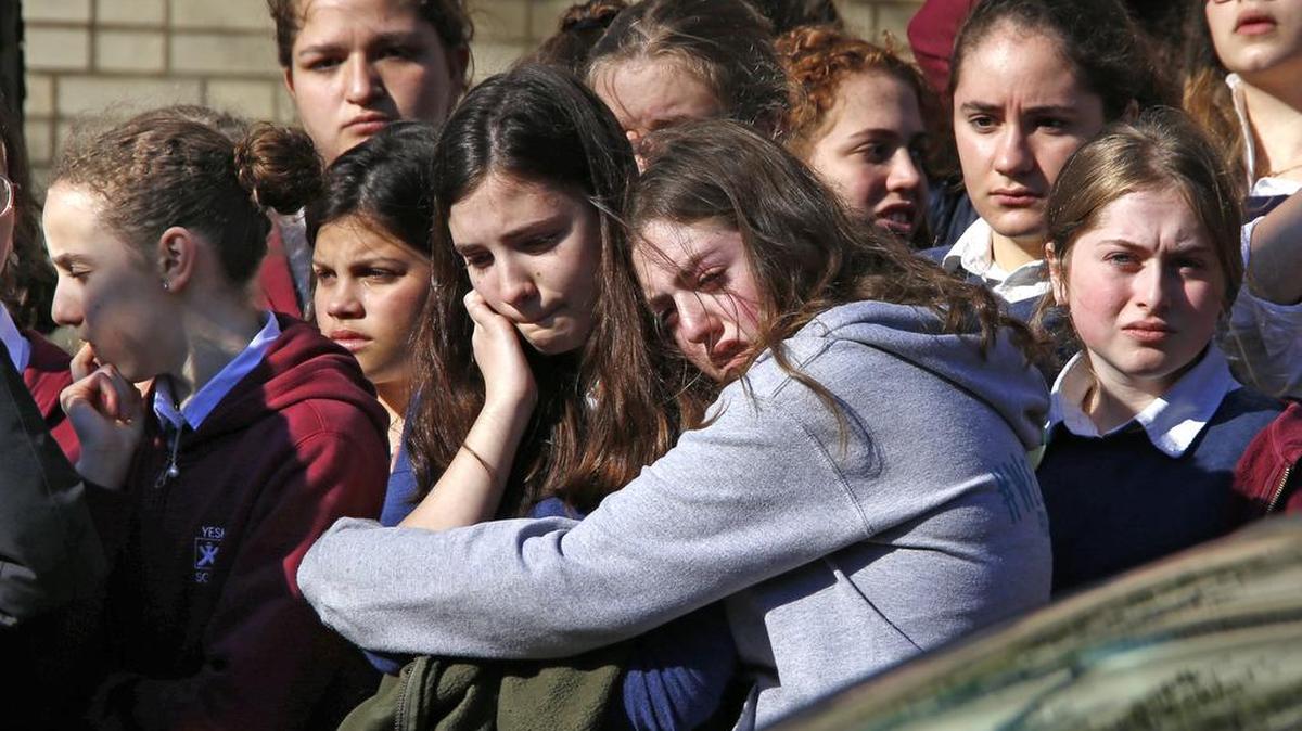 Students from the Yeshiva School in the Squirrel Hill neighborhood of Pittsburgh stand outside Beth Shalom Synagogue after attending the funeral service for Joyce Fienberg, Wednesday, Oct. 31, 2018. Joyce Fienberg, 75, was one of 11 people killed when a gunman opened fire during worship services at the Tree of Life Synagogue on Saturday, Oct. 27.
