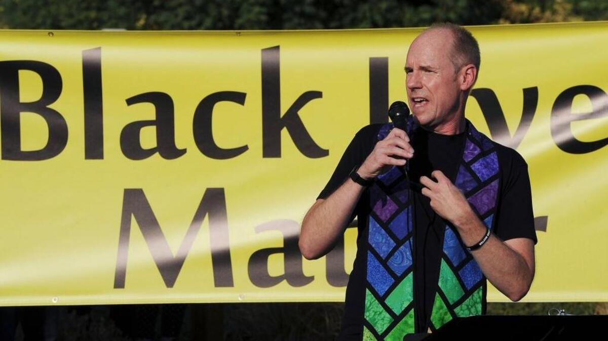 Unitarian Universalist Church of Fresno Rev. Tim Kutzmark addresses about 115 people gathered for the unveiling of twin Black Lives Matter banners outside the church along Alluvial Avenue Aug, 16. Kutzmark said the church's board decided they needed to spread the message that no lives will matter until all black lives, and those of people of color, mattered first. The twin banners can be seen from both directions of travel in front of the church.