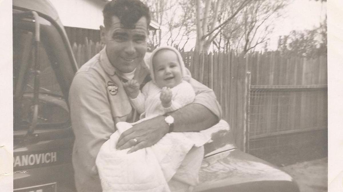 Steve Zupanovich, in his work uniform as owner of an oil distributorship in Chico, with baby Dana.