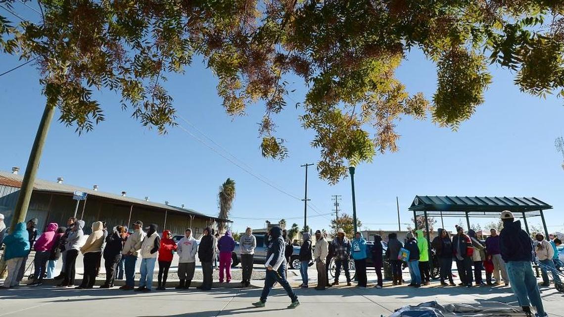 Residents line up to receive drought relief packages on Nov. 16, 2015, in Huron. To get the food packages, workers must either have had their hours reduced or have lost their jobs because of the drought or regulatory water restrictions.