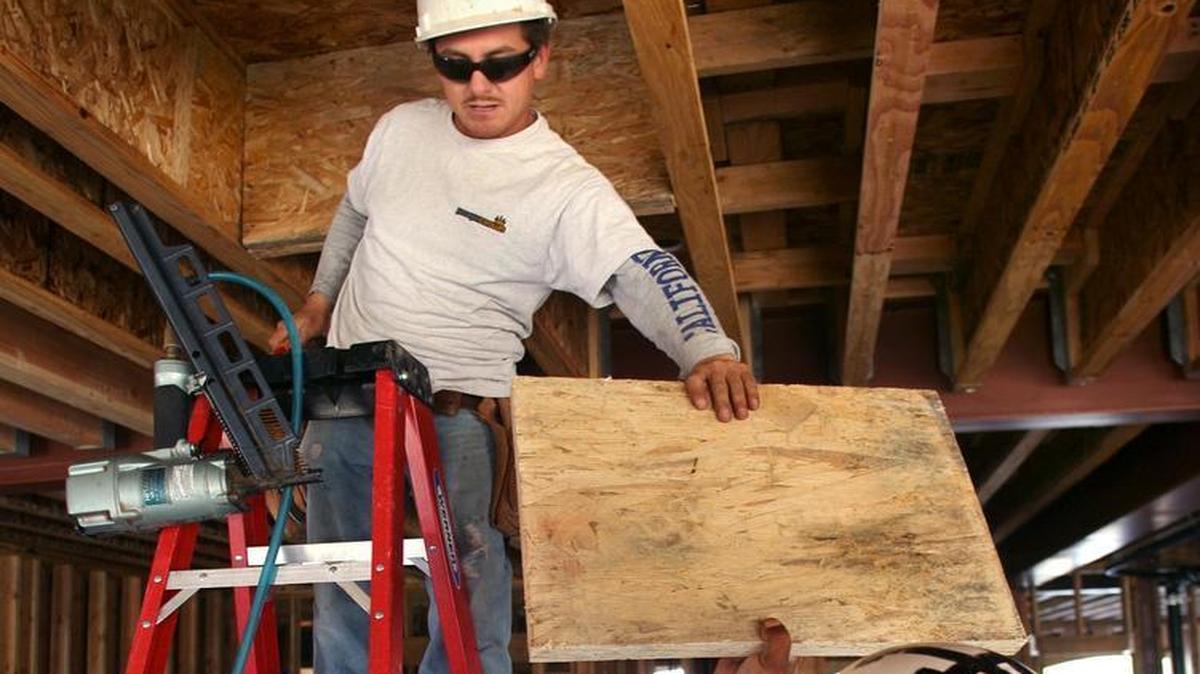 
Roberto Madrigal, left, and Manuel Sandate work on the interior construction of the Rose View Terrace in Clovis in 2011. Affordable housing construction in California largely has stalled, but state lawmakers and business leaders are trying to jump-start efforts again. 
