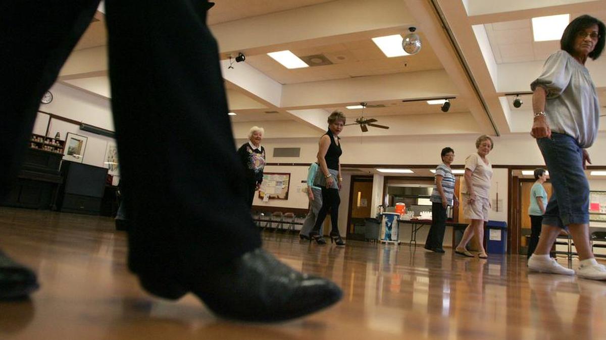 All eyes are on Jim Ray’s boots as he leads a Western line dancing class at the Clovis Senior Center in 2011.