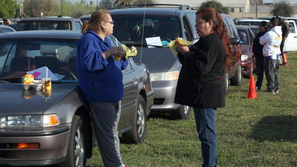 
Ramona Jimenez, left, and Angie Pico have breakfast while waiting for the Tune In & Tune Up event March 23, 2013. Tune In &Tune Up is program that identifies and helps repair older out-of-tune vehicles impacting air quality throughout the San Joaquin Valley. The next Tune In and Tune Up is Saturday, Sept. 26, at the International Ag Center in Tulare.
