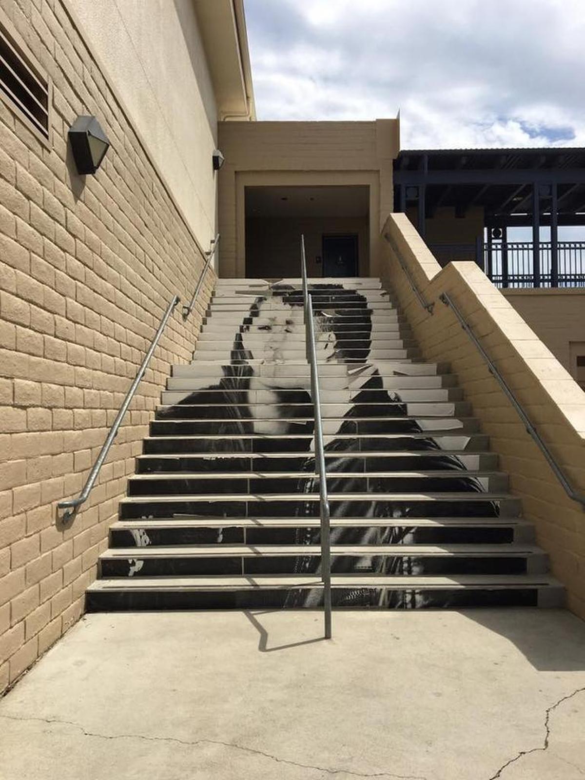 Several stairwells were made into murals by cutting the photo prints into strips and pasting them onto the stair step rises with wheat paste.
