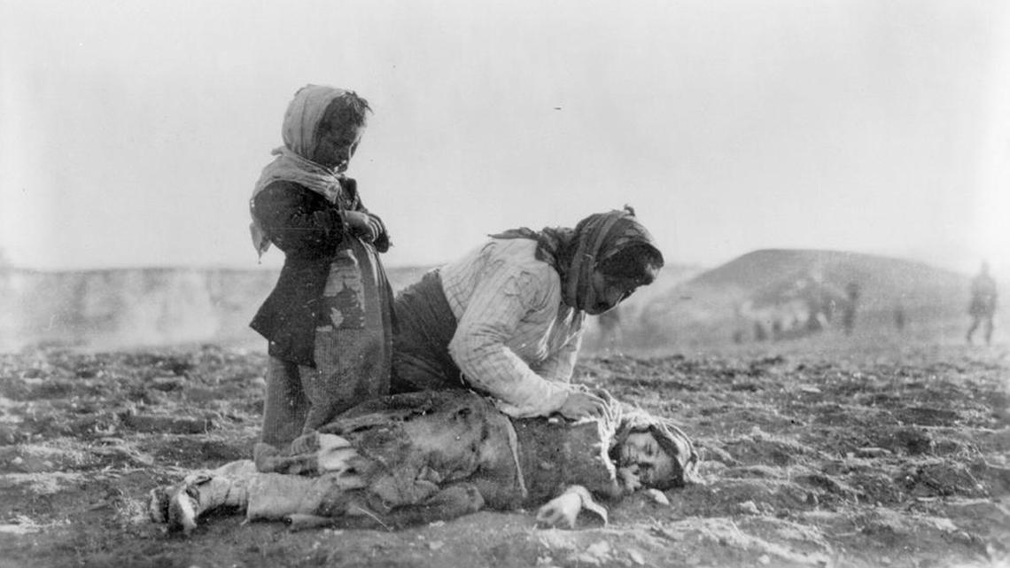 Armenian refugees in Syria in 1915. An Armenian child lies dead in the fields within sight of help and safety at Aleppo.