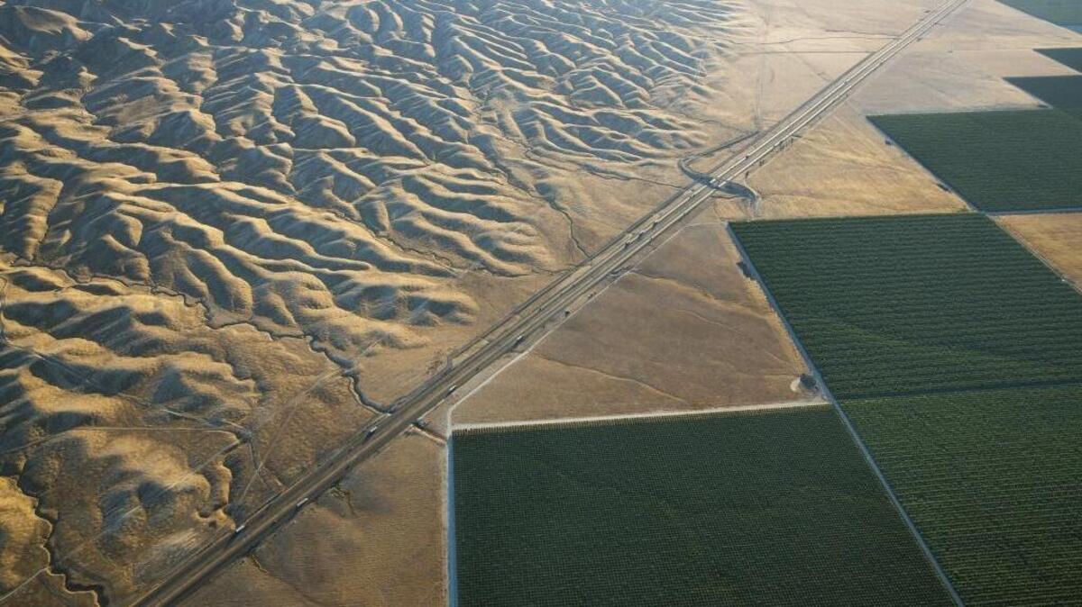 Irrigated fields in the Westlands Water District border Interstate 5 and the parched Diablo Range beyond, west of Tranquility. A state-created utility, Westlands seeks to keep water flowing to farms on the westside of Fresno and Kings counties.