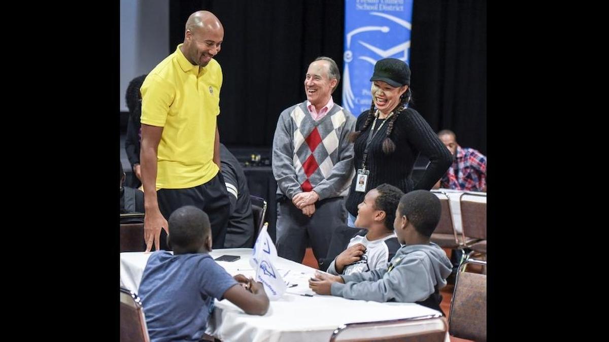 Fresno Unified assistant superintendent Holland Locker, center, shares a laugh with students and participants at a mentoring event.