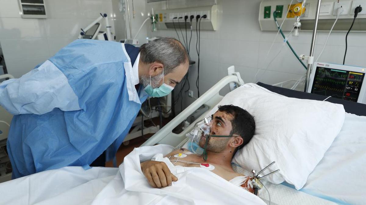 In this photo provided by the Armenian Prime Minister Press Service via PAN Photo, Armenian Prime Minister Nikol Pashinyan speaks to a wounded serviceman as he visits a military hospital in Yerevan, Armenia, Friday, Oct. 23, 2020. Heavy fighting is raging over Nagorno-Karabakh even as top diplomats from Armenia and Azerbaijan have traveled to Washington for negotiations on settling the neighboring countries’ decades-long conflict.