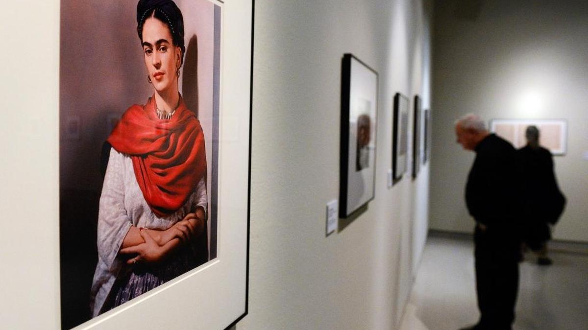 Visitors peruse Nickolas Muray photographs of Frida Kahlo on the opening night of the Fresno Art Museum’s winter-spring exhibitions, Friday, Jan. 22, 2016. A standing room-only crowd filled the Bonner Auditorium for a panel discussion and took part in a reception for the exhibits that also featured works by Anne Scheid, Sonia Romero and Richard G. Freitas, as well as the Fresno State Women RAD show.