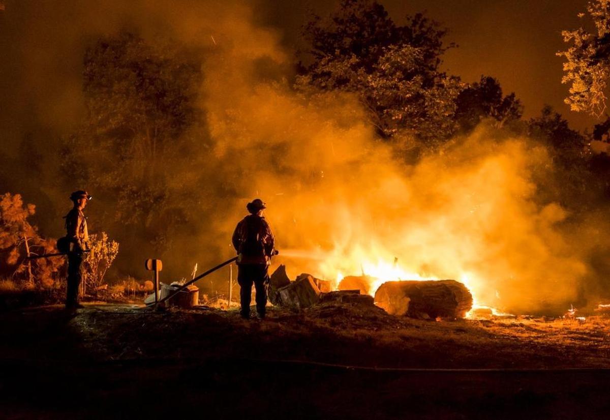 Firefighters monitor flames during the Mission Fire last September near the Madera County community of North Fork.