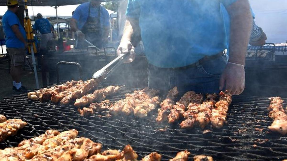 Volunteer Bob Crank turns marinated Greek chicken during the 57th Fresno Greek Fest.