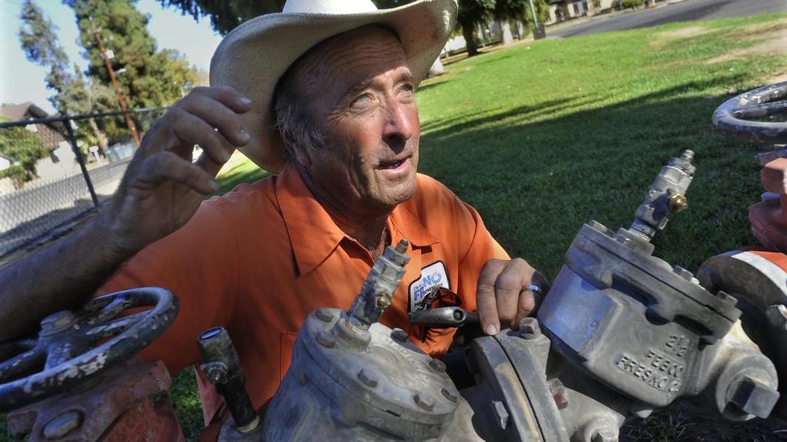 Wayne Fine, city of Fresno irrigation specialist, talks at a backflow device, which he tended to after damage to valves by vandals or homeless people camping in Roeding Park, who use pliers to turn, and thus, strip the brass as they attempt to gain access to water.