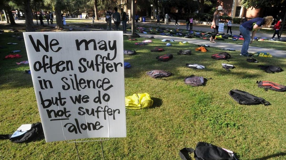 A message stands among the 1,100 backpacks at Fresno City College as part of the “Send Silence Packing” exhibit. The backpacks represent the 1,100 college students who die by suicide every year.
