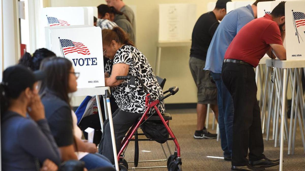 Voters fill the booths at the Fresno County Elections Office to cast their ballots in 2016.