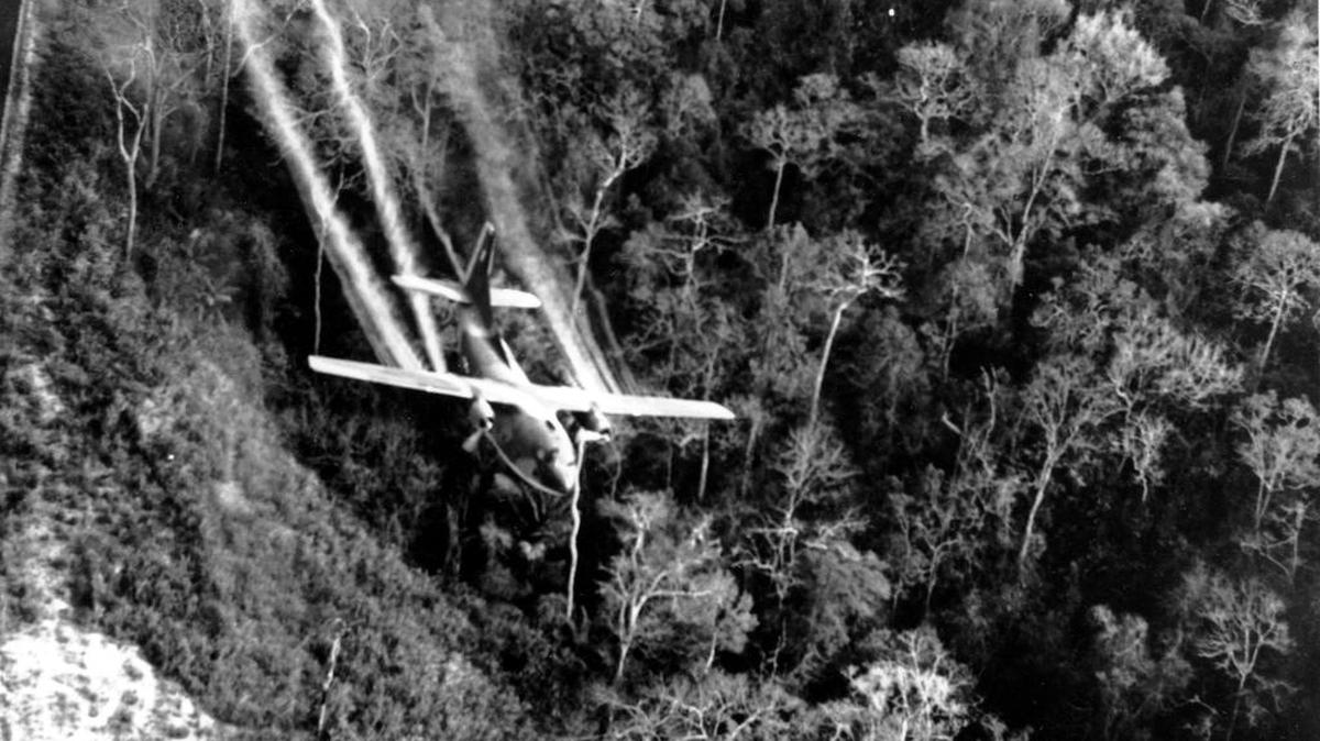 In this May 1966 file photo, a U.S. Air Force C-123 flies low along a South Vietnamese highway spraying defoliants on dense jungle growth beside the road to eliminate ambush sites for the Viet Cong during the Vietnam War. During the Vietnam War, Air Force C-123 planes sprayed millions of gallons of herbicides over the jungles of Southeast Asia to destroy enemy crops and tree cover. The war that people in the United States simply call Vietnam and the Vietnamese refer to as their Resistance War Against America has been over for 40-plus years, yet it lingers in so many ways.