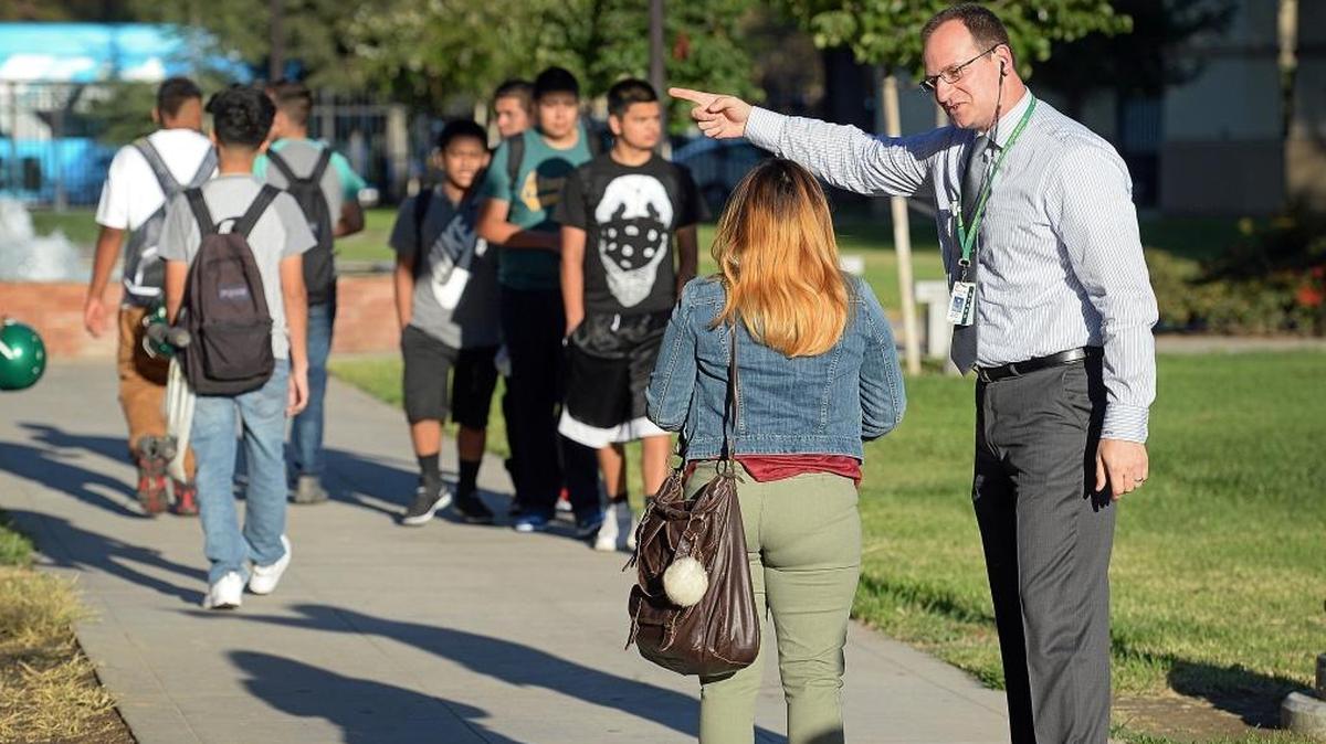 Roosevelt High School Principal Michael Allen directs students around campus before classes on the first day of school last August. Former county superintendent of schools Larry Powell says the Fresno Unified School District has a chance to remake itself into a district ready for the challenges of the digital age.