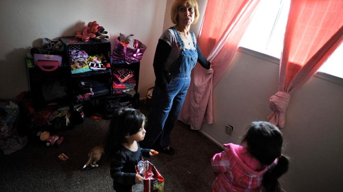 Sandra Machuca is with her granddaughters Francis Hernandez, 2, left, and sister Unique, 3, in the girls’ bedroom of their apartment in Fresno, Calif., on Wednesday, Jan. 27, 2016. The residence at the time was infested with bedbugs, requiring the girls to sleep on the floor.