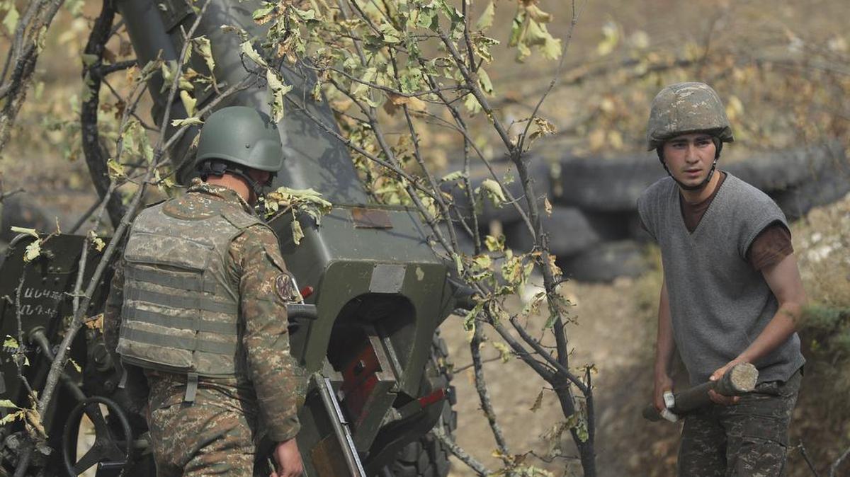 Ethnic Armenian soldiers fire an artillery piece at a fighting position on the front line, during a military conflict against Azerbaijan’s armed forces in the separatist region of Nagorno-Karabakh, Wednesday, Oct. 21, 2020. Armenia’s prime minister has urged citizens to sign up as military volunteers to help defend the country amid the conflict with Azerbaijan over the disputed territory of Nagorno-Karabakh as intense fighting has raged for a fourth week with no sign of abating. (Sipan Gyulumyan, Armenian Defense Ministry Press office/ PAN Photo via AP)
