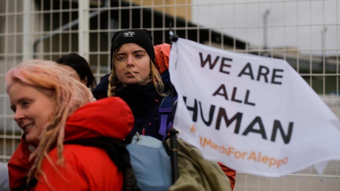 Demonstrators wait for the launch of the Civil March for Aleppo at the air field of the former airport Tempelhof in Berlin on Monday. With the march, they demand help for the people of Aleppo and other cities in Syria.