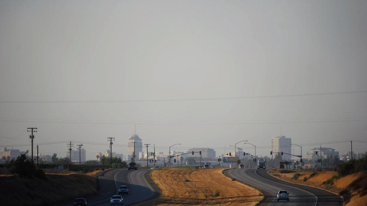 A haze prevents a clear view of downtown Fresno from Highway 41 near Easton late afternoon, July 31, 2013. Former Assembly member Alan Nakanishi, now on the Lodi City Council, says that billions of dollars raised through cap-and-trade auctions are squeezing Valley businesses while going to programs that don’t improve air quality,