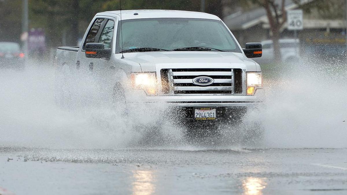 A truck splashes through a puddle at the intersection of North Maroa and West Bullard avenues on Jan. 31, 2016 in northwest Fresno.