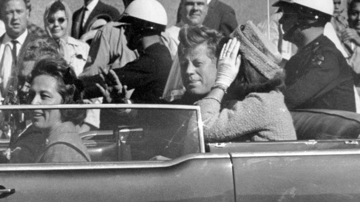 In this Nov. 22, 1963 file photo, President John F. Kennedy waves from his car in a motorcade in Dallas. Riding with Kennedy are First Lady Jacqueline Kennedy, right, Nellie Connally, second from left, and her husband, Texas Gov. John Connally, far left.