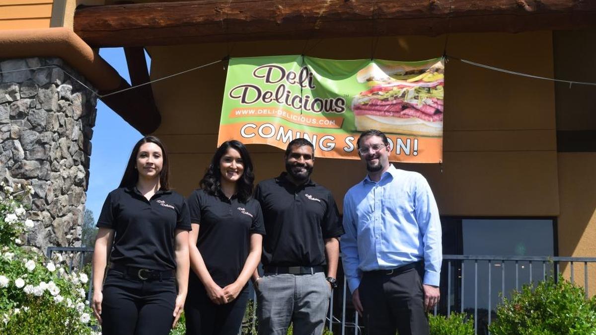 From left, manager Tessa Neiswonger, co-franchisees Mona and Nachhatar Sangha, and Nathan Gilbert of franchise development before they opened the Oakhurst Deli Delicious sandwich shop in 2016.