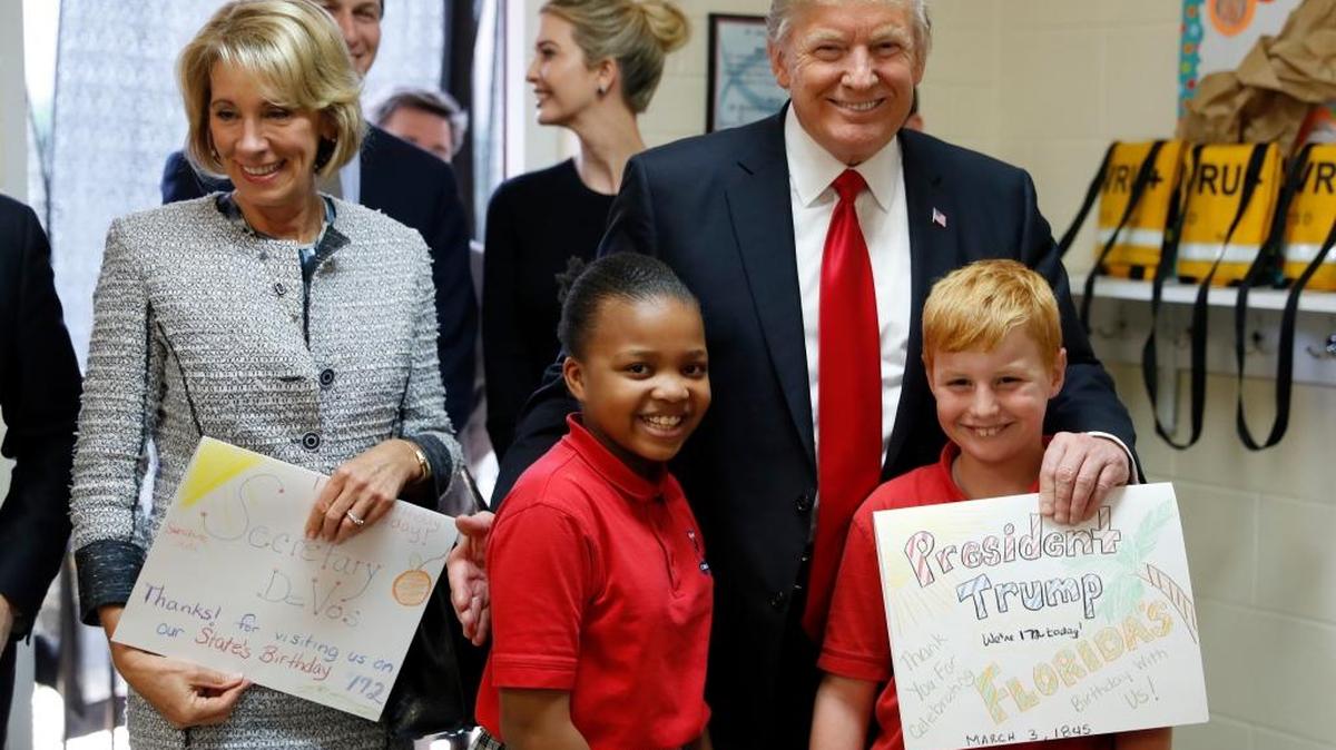 President Donald Trump and Education Secretary Betsy DeVos pose with fourth graders Janayah Chatelier, 10, left, Landon Fritz, 10, after they received cards from the children, during a tour of Saint Andrew Catholic School, Friday, March 3, 2017, in Orlando, Fla. Fresno writer Francine Farber wonders how Trump might be different had he attended preschool.