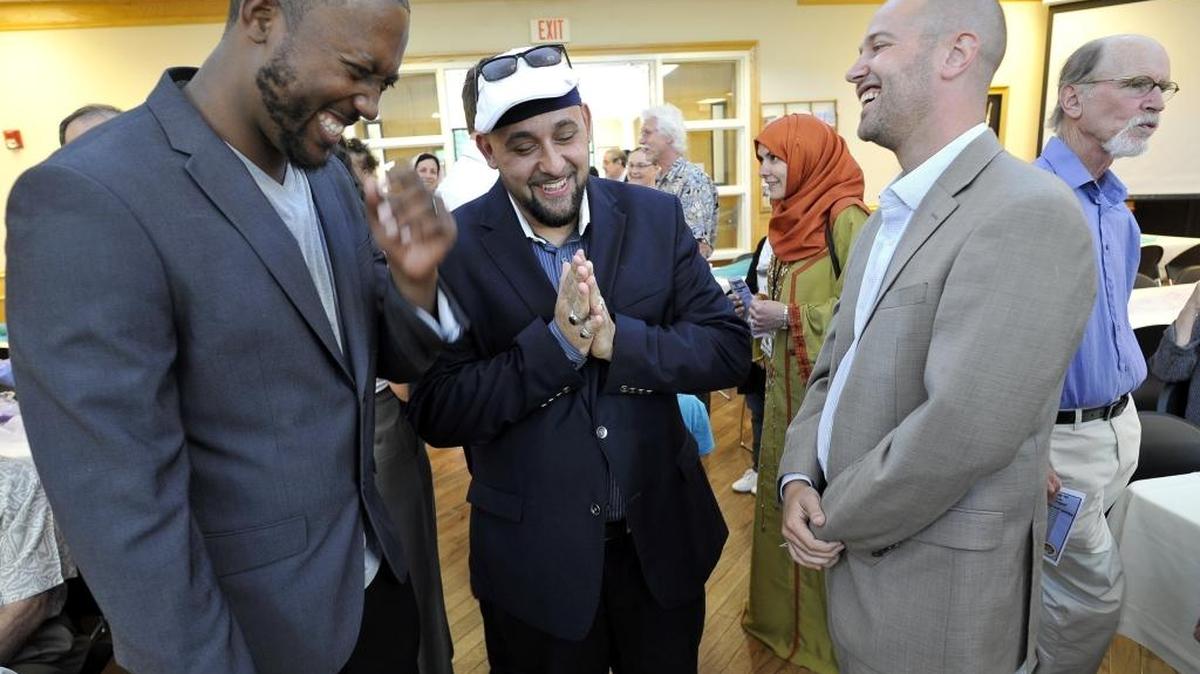 Faith in Community leaders Bryson White, left, Reza Nekumanesh, center, and Andy Levine share a light moment before a June 2015 awards ceremony at the Islamic Cultural Center of Fresno’s “Night of Spirituality,” where FIC was presented with the “Spirit of Abraham” award.